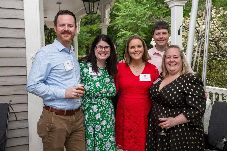 A group of people dressed up stand together for a photo. 